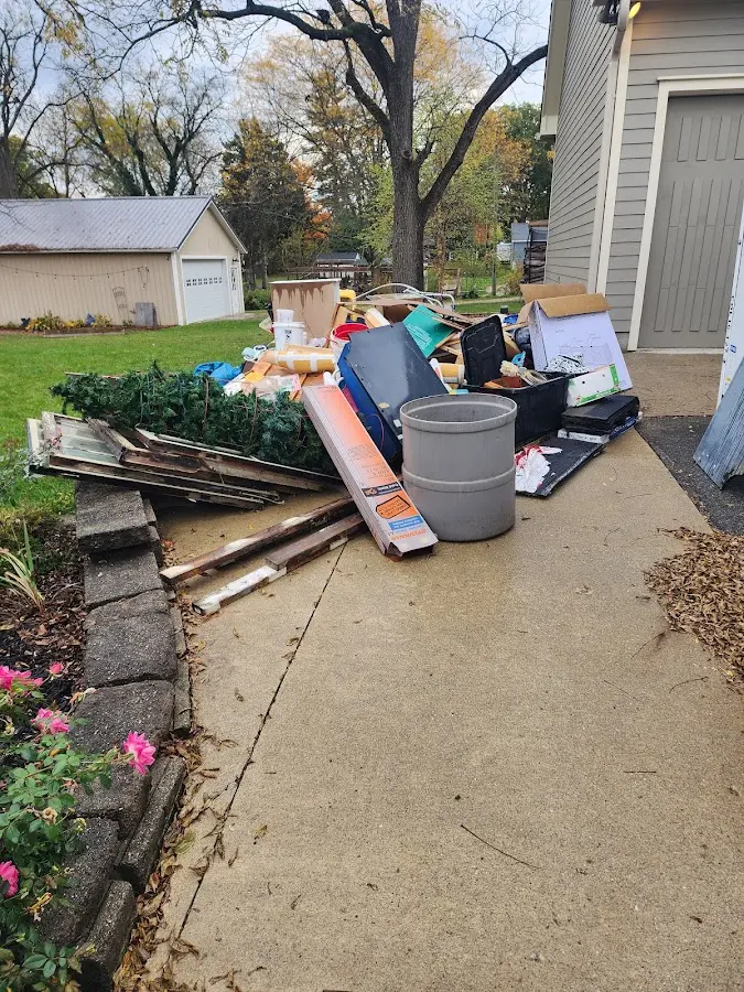 Dumpster being loaded with debris for Commercial Dumpster Rental in Aurora